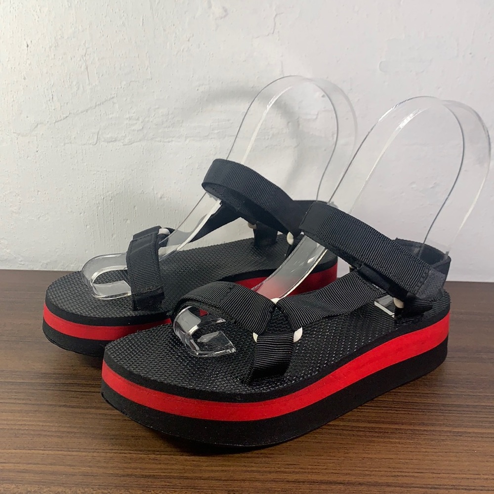 Black platform Teva size 8 with red stripe.